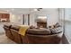 Living room featuring a comfortable leather sectional, modern entertainment center and lots of light at 2945 Torreon Ln, Las Vegas, NV 89121