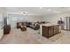 Open-concept living room and kitchen featuring tile and carpet at 2945 Torreon Ln, Las Vegas, NV 89121