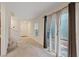 Bright living room features sliding doors, carpet, and neutral walls at 2945 Torreon Ln, Las Vegas, NV 89121