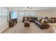 Open-concept living room featuring carpet, a leather sofa, and a ceiling fan at 2945 Torreon Ln, Las Vegas, NV 89121