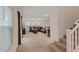Open living room with a large dark brown sectional couch, ceiling fan, and staircase at 2945 Torreon Ln, Las Vegas, NV 89121