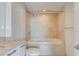 Bright bathroom featuring a soaking tub with tile surround and chrome fixtures at 322 Karen Ave # 2003, Las Vegas, NV 89109