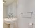 Bathroom pedestal sink with chrome faucet, mirror and towel racks at 322 Karen Ave # 2003, Las Vegas, NV 89109