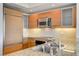 Kitchen with stainless steel appliances, wooden cabinets and a granite countertop at 322 Karen Ave # 2003, Las Vegas, NV 89109