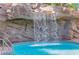 Beautiful waterfall feature cascading into a sparkling pool, creating a serene oasis at 322 Karen Ave # 2003, Las Vegas, NV 89109
