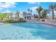 Resort-style pool surrounded by tropical palm trees and comfortable lounge chairs at 322 Karen Ave # 2003, Las Vegas, NV 89109