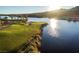 Picturesque golf course on a sunny day, featuring lush green fairways and a serene lakefront setting at 33 Desert Juniper Ln, Henderson, NV 89011