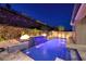 Beautiful pool with a waterfall feature and landscape lighting for an evening oasis at 33 Desert Juniper Ln, Henderson, NV 89011