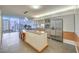 Contemporary kitchen with stainless steel appliances, island, dining area, and stunning cityscape vistas at 3722 Las Vegas Blvd # 1204, Las Vegas, NV 89158