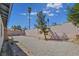Gravel backyard featuring desert landscaping, including trees and cactus and block wall fencing for privacy at 3747 N Braewood South Ave, Las Vegas, NV 89120