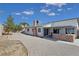 Large backyard with gravel landscaping, a covered patio with an outdoor kitchen, and privacy fencing at 3747 N Braewood South Ave, Las Vegas, NV 89120