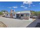 Spacious backyard with gravel landscaping and a covered patio featuring an outdoor kitchen at 3747 N Braewood South Ave, Las Vegas, NV 89120