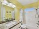Full bathroom features granite counters, framed mirror and tub with shower at 3747 N Braewood South Ave, Las Vegas, NV 89120