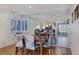 Dining area with seating for four, mirrored wall, and views into living room at 3747 N Braewood South Ave, Las Vegas, NV 89120