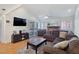 Comfortable living room with vaulted ceiling, brick fireplace, and modern furnishings at 3747 N Braewood South Ave, Las Vegas, NV 89120
