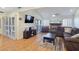 Cozy living room featuring a brick fireplace, ceiling fan, and sliding doors at 3747 N Braewood South Ave, Las Vegas, NV 89120