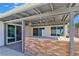 A covered patio has an outdoor brick kitchen and multiple sliding glass door entrances to the home at 3747 N Braewood South Ave, Las Vegas, NV 89120
