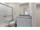 Modern bathroom featuring a glass-enclosed shower, white tile, and a sleek vanity at 4249 Gold Desert St, North Las Vegas, NV 89032