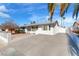 Charming single-story home with a spacious driveway and well-maintained landscaping, palm tree in the front yard at 4320 E Wyoming Ave, Las Vegas, NV 89104