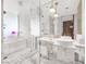 Modern bathroom with marble tiling, dual sinks, ample counter space, and glass enclosed shower/tub combination at 4381 W Flamingo Rd # 3712, Las Vegas, NV 89103