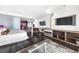 Spacious bedroom with modern furnishings, a desk, and a mounted television at 4381 W Flamingo Rd # 3712, Las Vegas, NV 89103