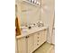 Well-lit bathroom with double sinks, white cabinets, and a large mirror at 4534 Regalo Bello St, Las Vegas, NV 89135