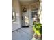 Front door with a decorative wreath and a welcoming mat, enhanced by lush greenery and charming accents at 4534 Regalo Bello St, Las Vegas, NV 89135