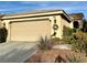 Exterior of home showcasing the two-car garage and manicured front yard, including desert landscaping and healthy shrubs at 4534 Regalo Bello St, Las Vegas, NV 89135