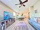 Comfortable living room with a large television, stylish furnishings, and a ceiling fan at 4534 Regalo Bello St, Las Vegas, NV 89135
