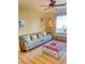 Comfortable living room showing a ceiling fan, window with sunlight, plush seating, and a stylish rug at 4534 Regalo Bello St, Las Vegas, NV 89135