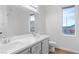 Bathroom with double sinks, a large mirror, and natural light at 4905 Madre Maria Ct, North Las Vegas, NV 89031