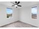 Bright bedroom featuring neutral walls, wood-look floors, and a modern ceiling fan at 4905 Madre Maria Ct, North Las Vegas, NV 89031