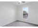 This bedroom offers neutral walls and carpet with a ceiling fan and window at 4905 Madre Maria Ct, North Las Vegas, NV 89031