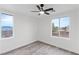 Bedroom with wood-look flooring, bright windows, and a modern ceiling fan at 4905 Madre Maria Ct, North Las Vegas, NV 89031