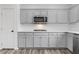 Stylish kitchen featuring stainless steel appliances, gray cabinets, and quartz countertops at 4905 Madre Maria Ct, North Las Vegas, NV 89031