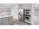 This is a kitchen with stainless steel appliances and gray cabinets and countertops at 4905 Madre Maria Ct, North Las Vegas, NV 89031