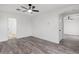 Spacious living room featuring gray wood-look floors and a modern ceiling fan at 4905 Madre Maria Ct, North Las Vegas, NV 89031