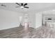 Open-concept living room with wood-look tile flooring flowing into the kitchen and dining areas at 4905 Madre Maria Ct, North Las Vegas, NV 89031