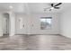 Spacious living room with wood-look tile flooring, a decorative front door and large window at 4905 Madre Maria Ct, North Las Vegas, NV 89031