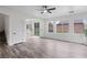Bright and airy living room with wood-look tile floors and plenty of natural light from large windows at 4905 Madre Maria Ct, North Las Vegas, NV 89031