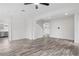 Bright open-concept living area showcasing wood-look floors, open staircase, and modern kitchen at 4905 Madre Maria Ct, North Las Vegas, NV 89031