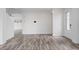 Open living area with archways, wood-look tile, and a decorative front door providing natural light at 4905 Madre Maria Ct, North Las Vegas, NV 89031