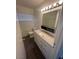 Bathroom featuring modern vanity with countertop, a rectangular mirror at 5129 Sugarfoot Ave, Las Vegas, NV 89107