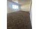 Spacious living room with new carpeting, large window, and light walls at 5129 Sugarfoot Ave, Las Vegas, NV 89107