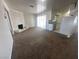 Open-concept living room with fireplace and access to the kitchen and sliding glass door at 5129 Sugarfoot Ave, Las Vegas, NV 89107