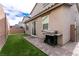 A charming backyard with artificial grass, brick pavers, and a built-in grill for outdoor enjoyment at 6130 Sinks Canyon Ave, Las Vegas, NV 89130