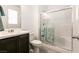 Bathroom with clear glass shower door, bench, vanity and white tiling at 6130 Sinks Canyon Ave, Las Vegas, NV 89130