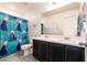 Bright bathroom with double vanity, toilet, and shower with Frozen-themed curtain at 6130 Sinks Canyon Ave, Las Vegas, NV 89130