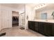 Bright bathroom with double vanity, walk-in shower, and entry to a walk-in closet at 6130 Sinks Canyon Ave, Las Vegas, NV 89130