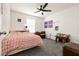 Cozy bedroom with soft carpet, a ceiling fan, and ample natural light at 6130 Sinks Canyon Ave, Las Vegas, NV 89130